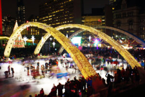 People ice-skating in Toronto's Nathan Phillips Square during Christmas as a holiday event